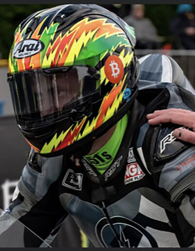Matt Mychreets on the Isle of Man TT start line wearing a custom painted helmet by X-Paint