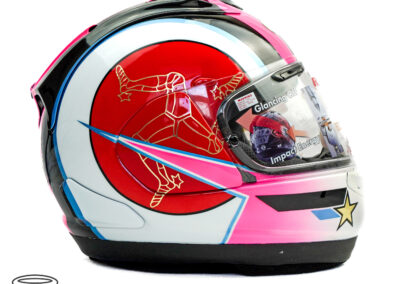 Paul Cassidy Isle of Man TT 2024 Helmet right side view - with a gold chrome triskelion on a circular red background with a fluorescent pink bolt through it that is outlined in a pearlescent blue outline