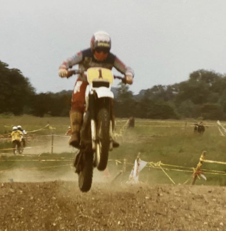 iain racing a yamaha yz125 in 1982 during a stevenage schoolboy scrambling event at cheshunt in hertfordshire wearing an early custom painted helmet