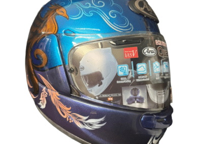X-Paint signed custom Arai Quantic helmet with phoenix and feather airbrush design in gold, blush and white on violet blue metallic
