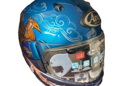 Custom painted Arai Quantic helmet side view with flowing feather detail in pale pink and white on violet to blue metallic fade