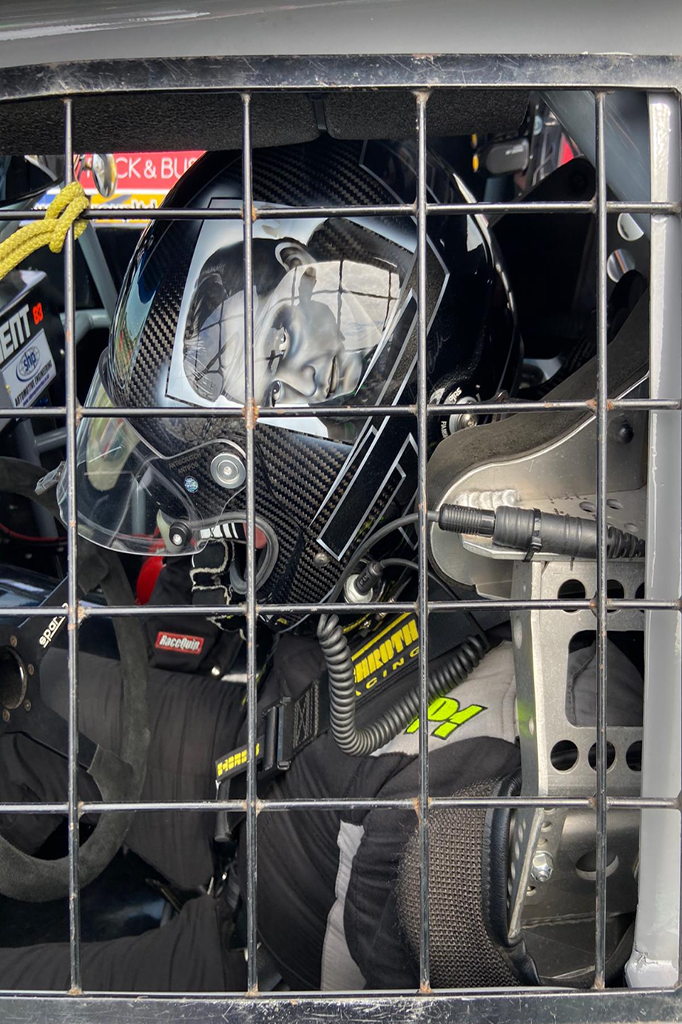 Dale Gent in the cockpit of his racing pick up wearing the iconic Jonny Cash helmet painted by X-Paint