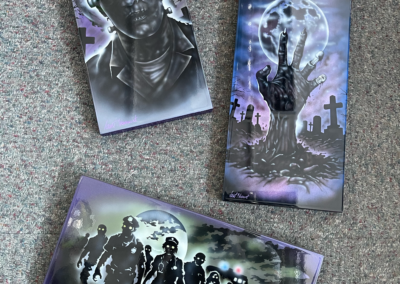 3 pieces of art featuring airbrushed zombie images
