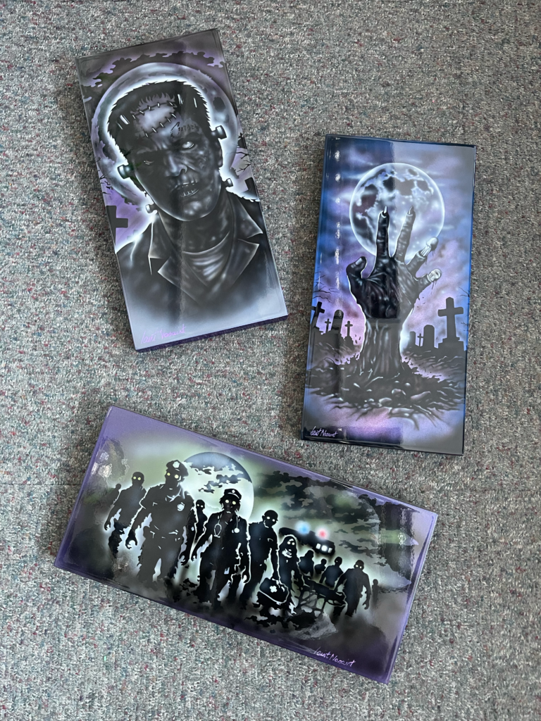 3 pieces of art featuring airbrushed zombie images