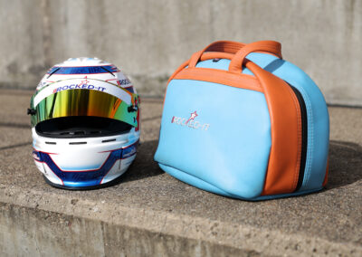 a race helmet pictured next to its custom made bag